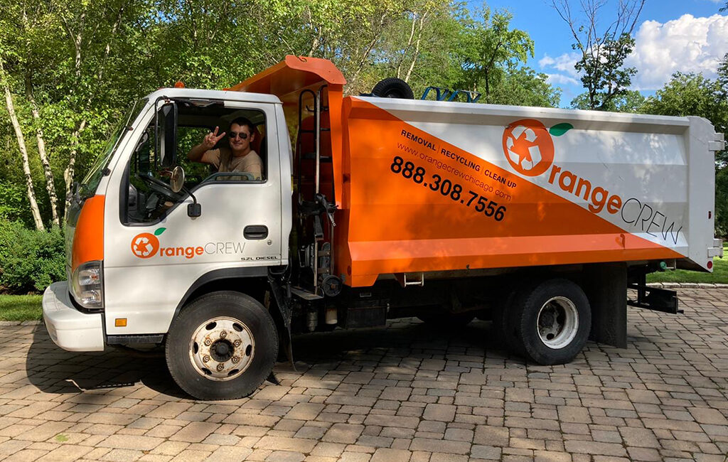 man sitting in the orange crew truck