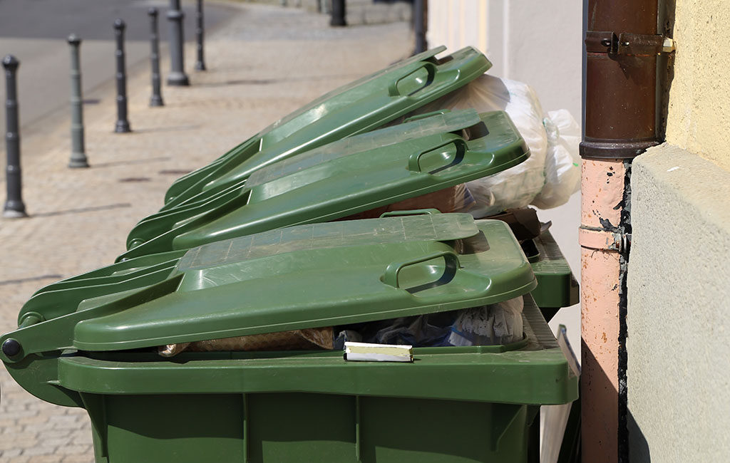 3 green trash bins