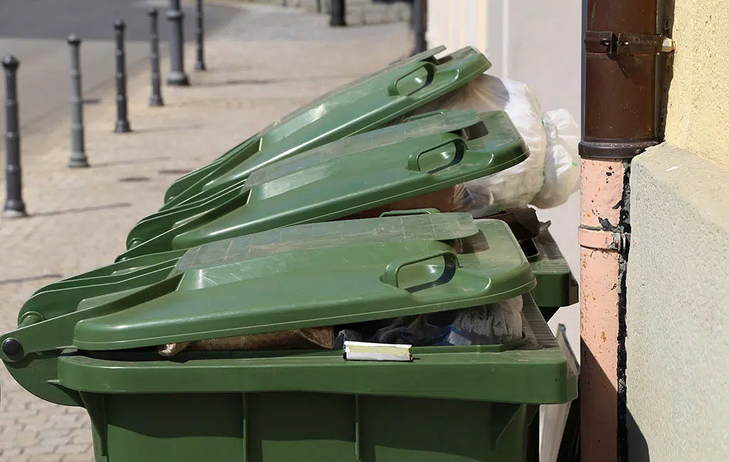 3 green trash bins