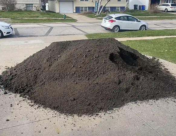 pile of dirt on a residential driveway