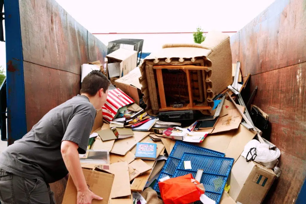 man hauling junk in truck
