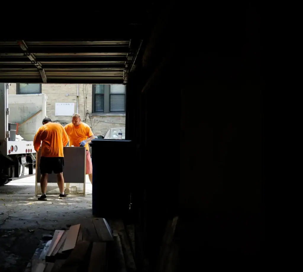 two men in the distance working on garbage removal project