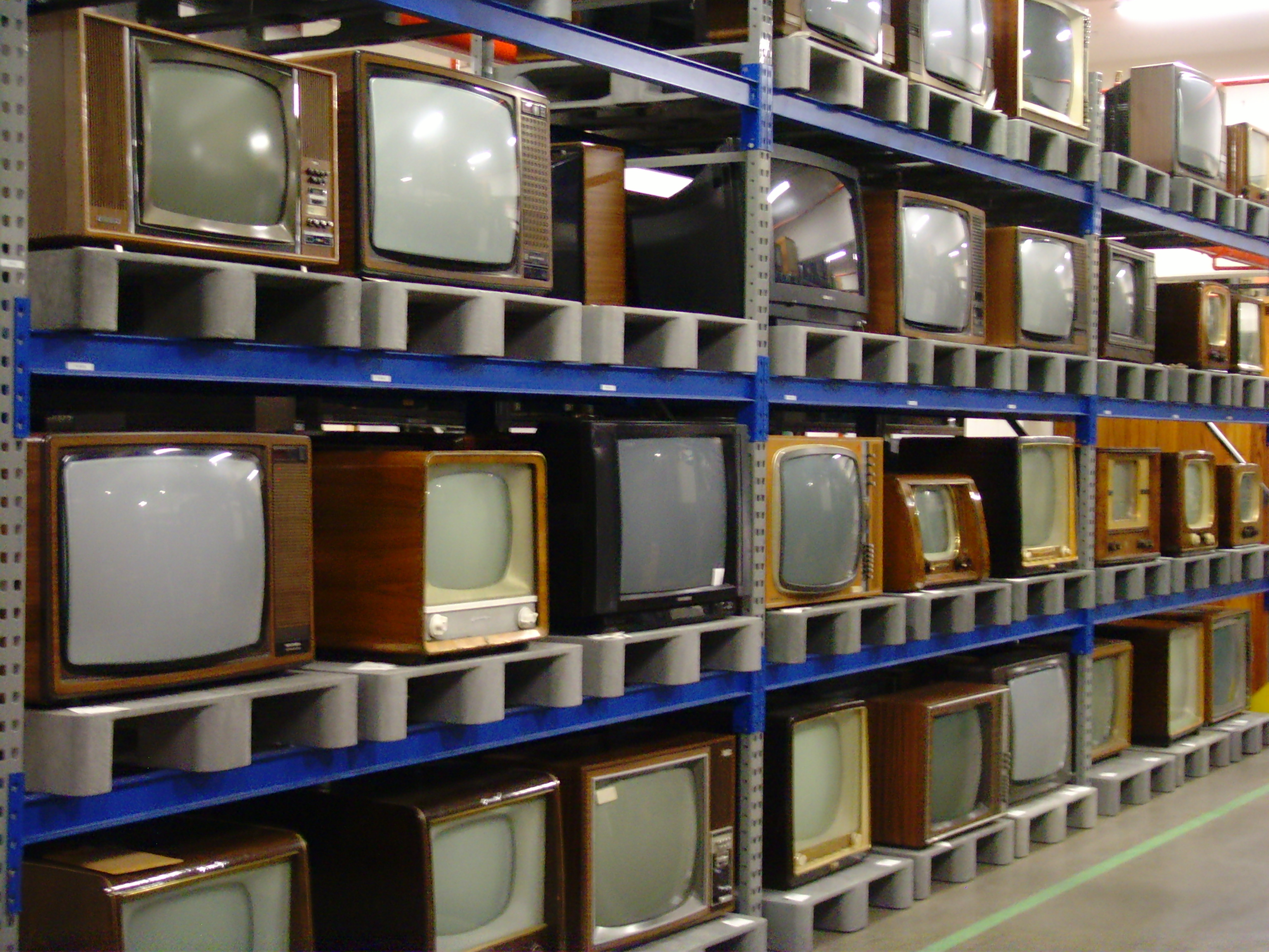 Rows of old CRT tube televisions collected for hazardous e-waste recycling