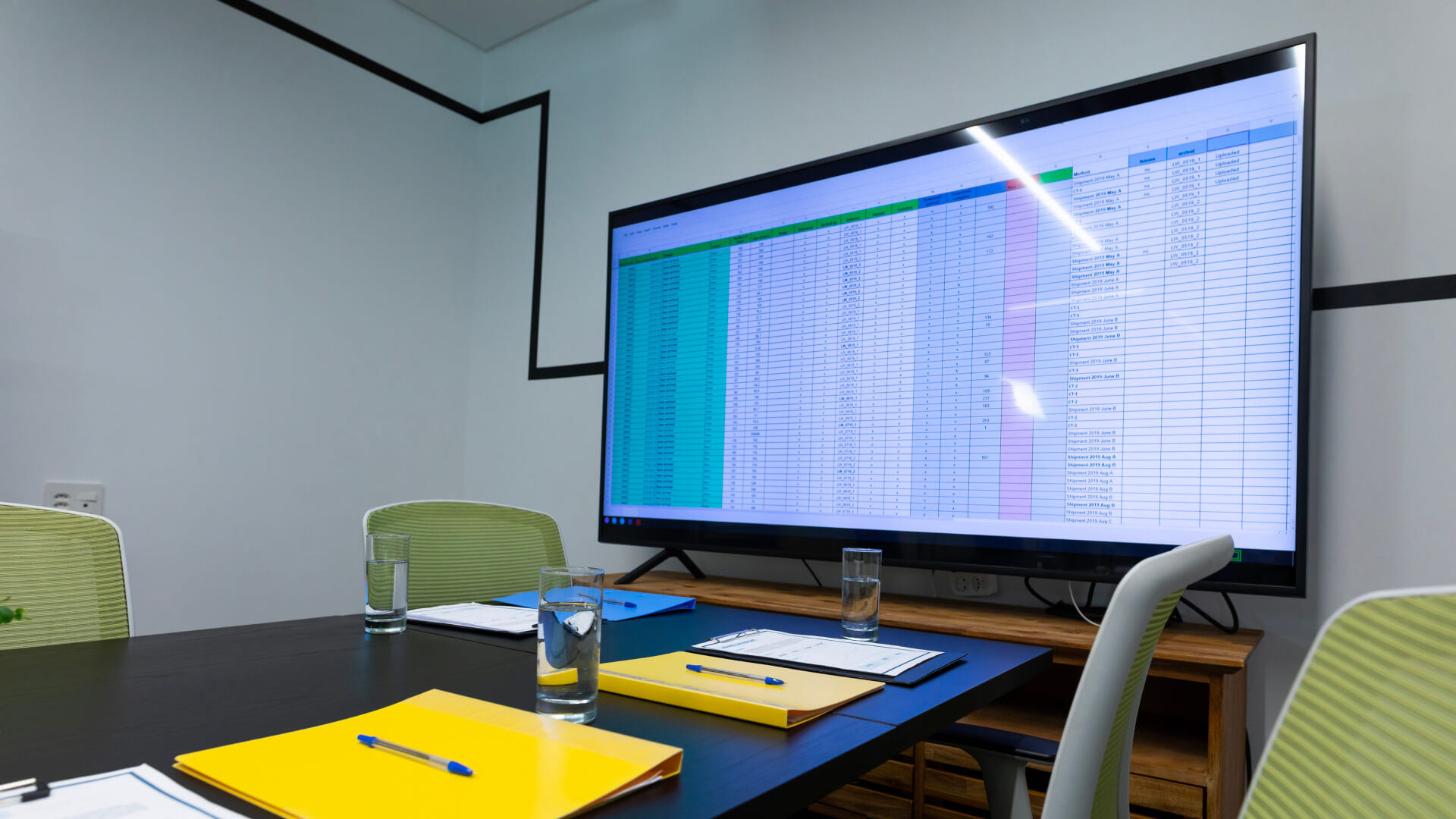 Large wall-mounted office display screen in a conference room, ready for removal