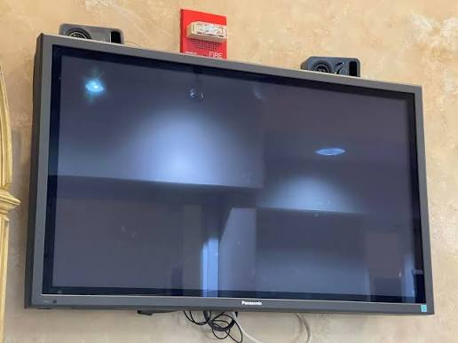 Wall-mounted Panasonic plasma TV taken down for removal and recycling
