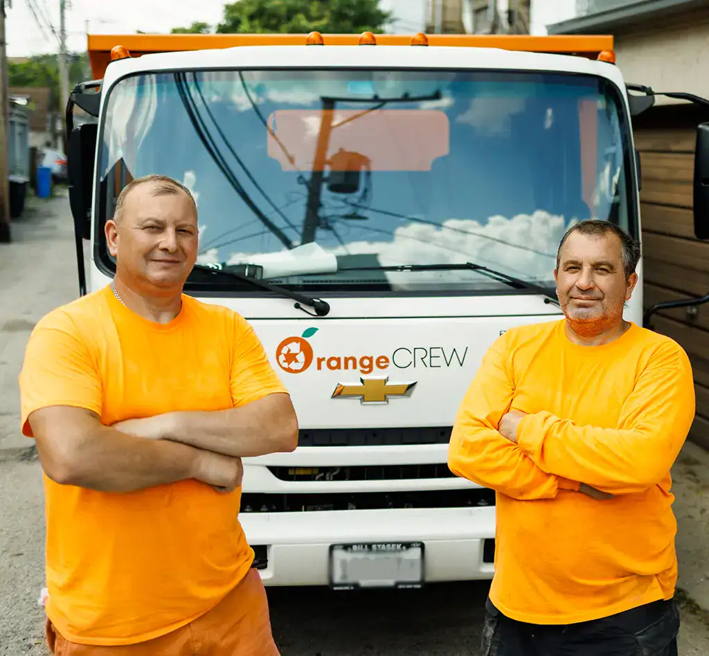 friendly looking junk haulers next to Orange Crew truck